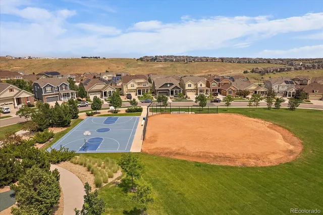 an aerial view of a residential houses with outdoor space and ocean view