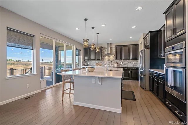 a living room with couches and a large window