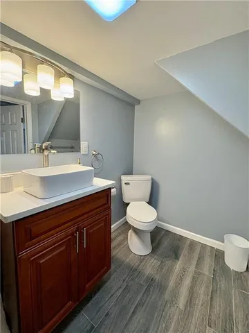 a bathroom with a toilet sink and mirror