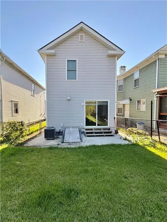 a view of a house with a backyard and a patio