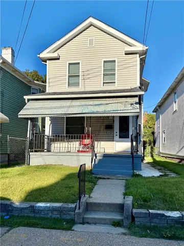 a front view of house with yard and green space