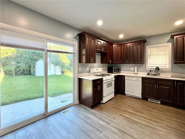 a kitchen with a sink a window and stainless steel appliances