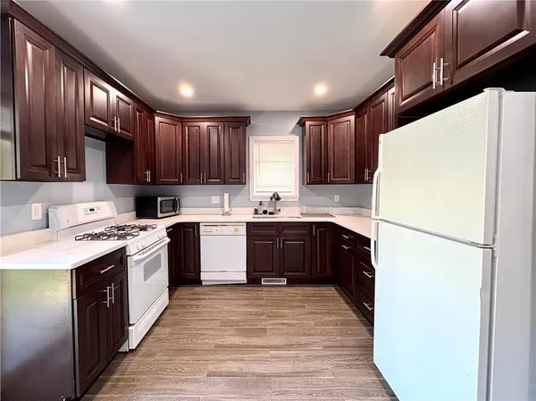 a kitchen with a sink a stove a refrigerator and cabinets