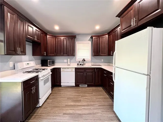 a kitchen with a sink a stove a refrigerator and cabinets