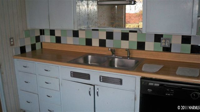 690 Lester Avenue Reno, NV 89502 - Photo 6 of 13 a kitchen with stainless steel appliances a sink and cabinets