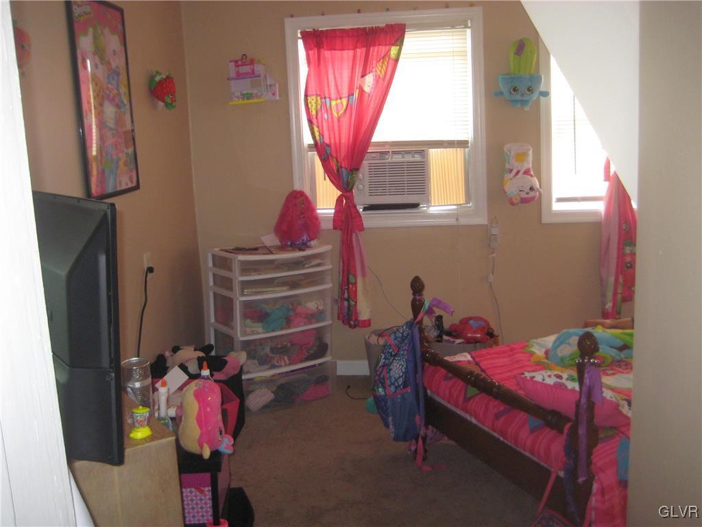 1003 Spring Street Bethlehem, PA 18018 - Photo 3 of 13 a bedroom with a bed and a window