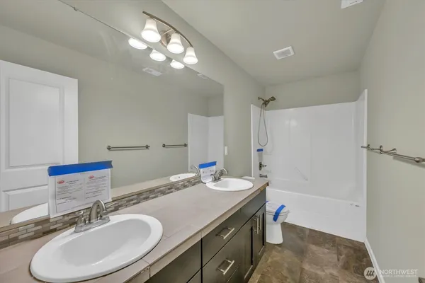 a bathroom with a sink double vanity and a mirror