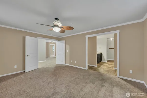 a view of empty room with ceiling fan