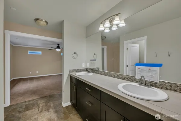 a bathroom with a sink double vanity and a mirror
