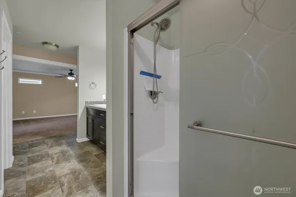 a bathroom with a shower and a sink