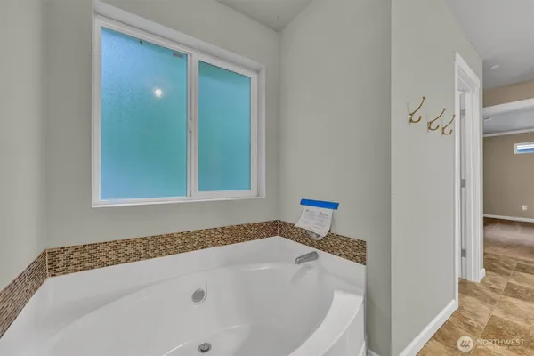 a bathroom with a bathtub and a window