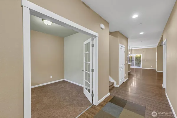 a view of a hallway with wooden floor