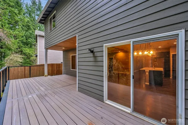 a view of backyard with a deck and wooden floor
