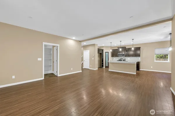 a view of a kitchen with wooden floor and a sink