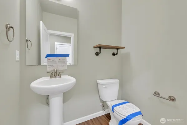 a bathroom with a sink toilet and a mirror