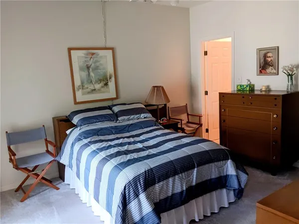 a bedroom with a bed and dresser