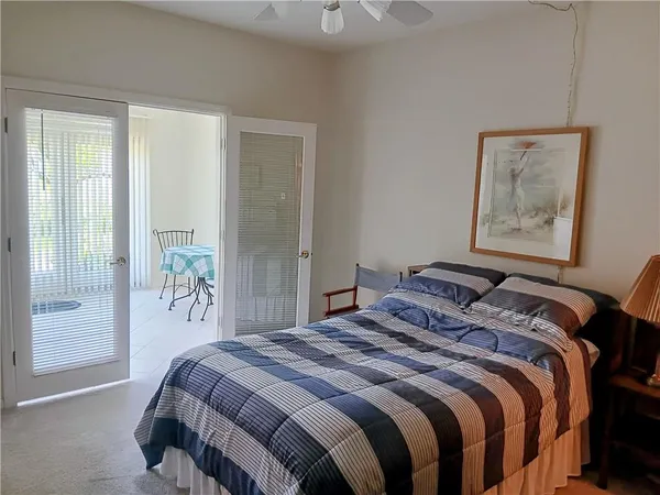 a bedroom with a bed and a painting on the wall