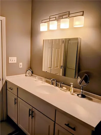 a bathroom with a double vanity sink and a mirror