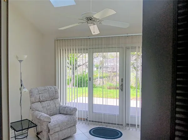 a living room with furniture and a floor to ceiling window