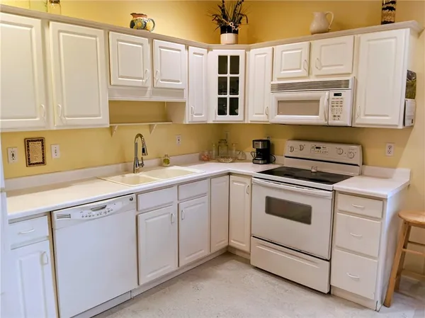 a kitchen with stainless steel appliances granite countertop a sink and cabinets