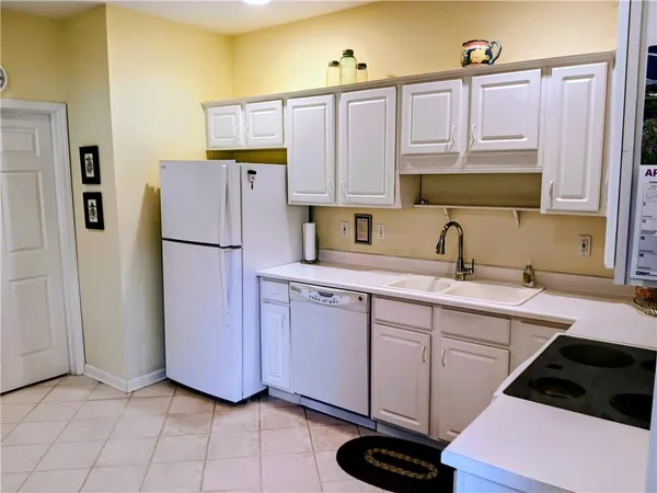a kitchen with a refrigerator and a sink