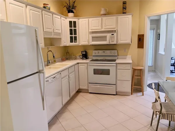 a kitchen with stainless steel appliances a refrigerator sink and cabinets