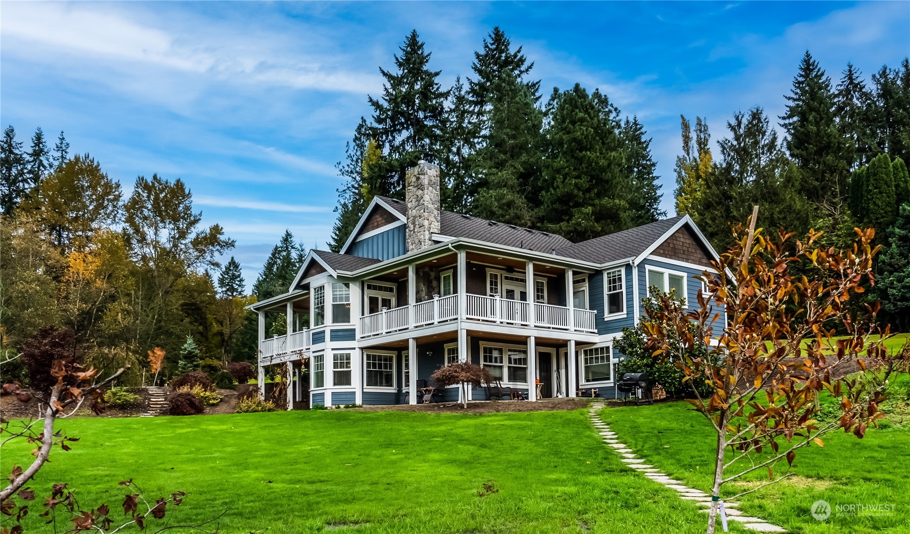 7124 Maltby Road Woodinville, WA 98072 - Photo 1 of 1 a view of a house with a big yard and large trees
