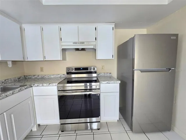 a kitchen with cabinets and stainless steel appliances