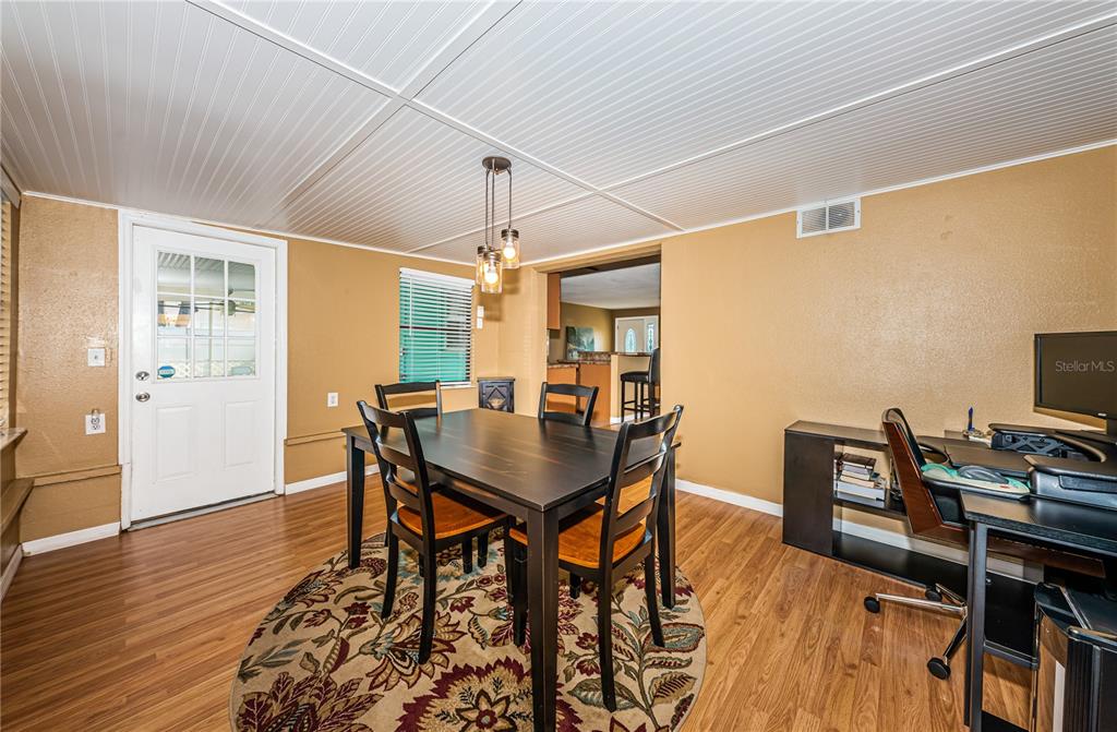 1738 Bentley Street Clearwater, FL 33755 - Photo 16 of 30 a view of a dining room with furniture and wooden floor