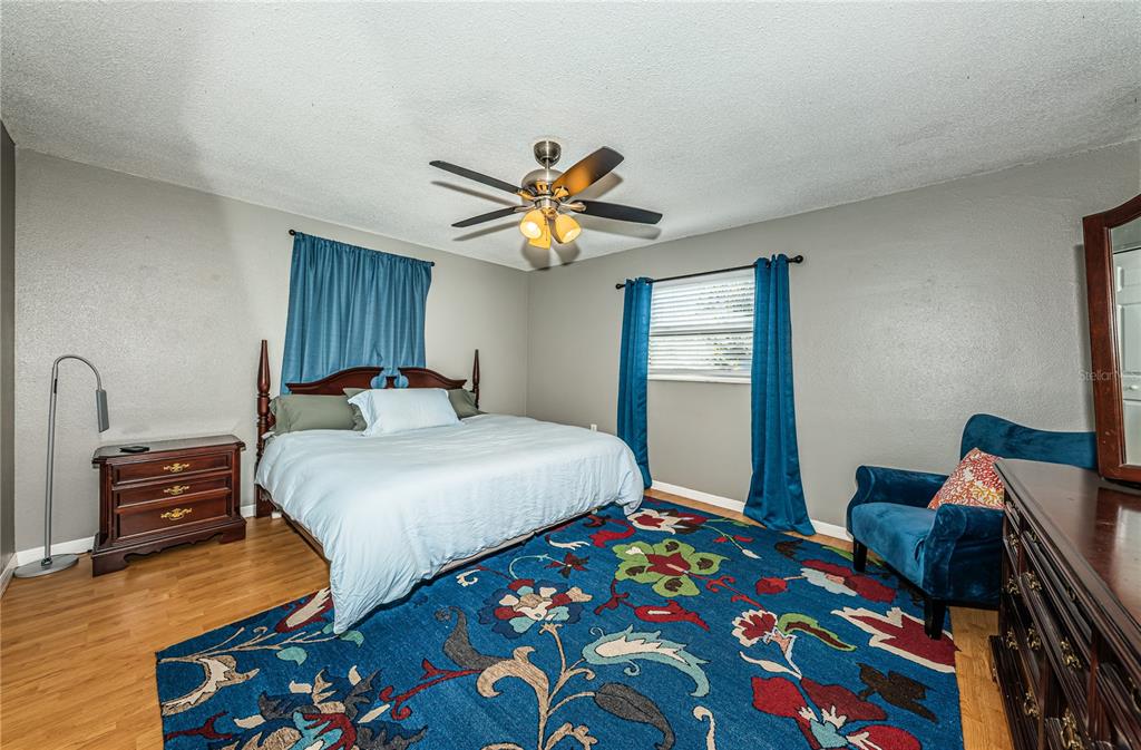 1738 Bentley Street Clearwater, FL 33755 - Photo 17 of 30 a bedroom with bed and wooden floor