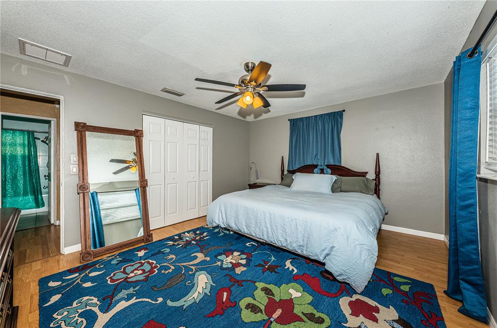 1738 Bentley Street Clearwater, FL 33755 - Photo 18 of 30 a bedroom with a bed and wooden floor