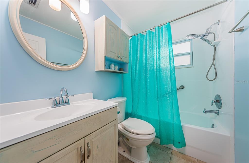 1738 Bentley Street Clearwater, FL 33755 - Photo 19 of 30 a bathroom with a sink a toilet and a mirror