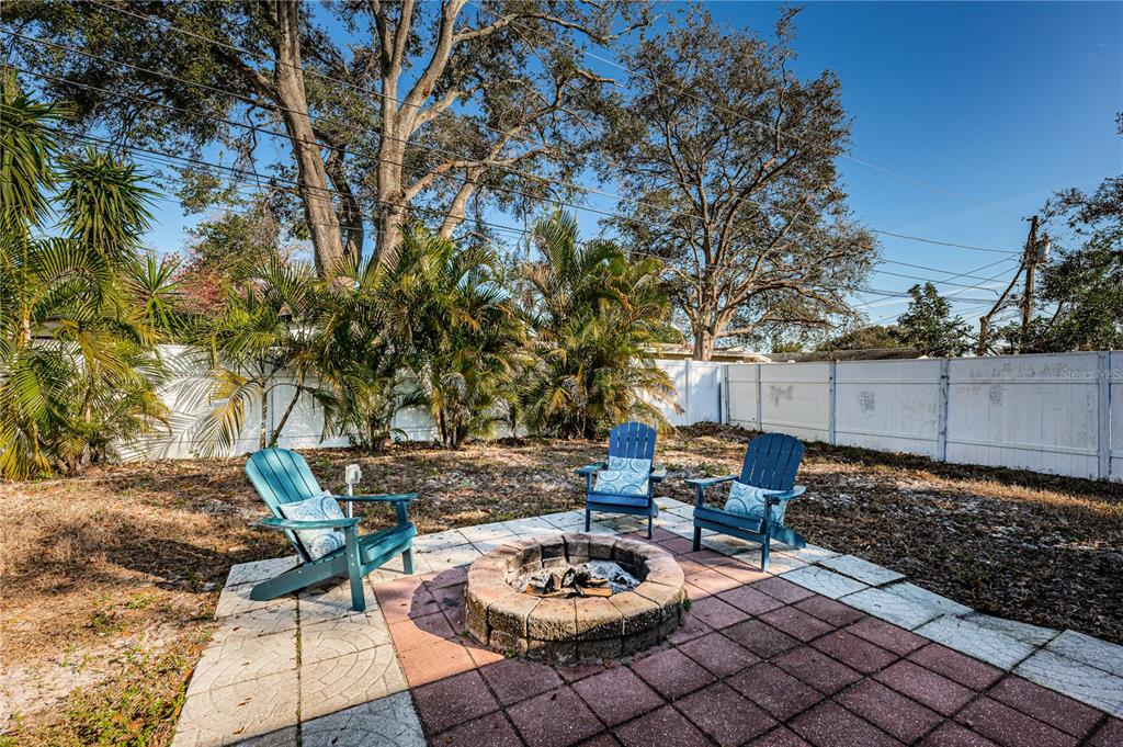 1738 Bentley Street Clearwater, FL 33755 - Photo 24 of 30 a backyard of a house with barbeque oven table and chairs