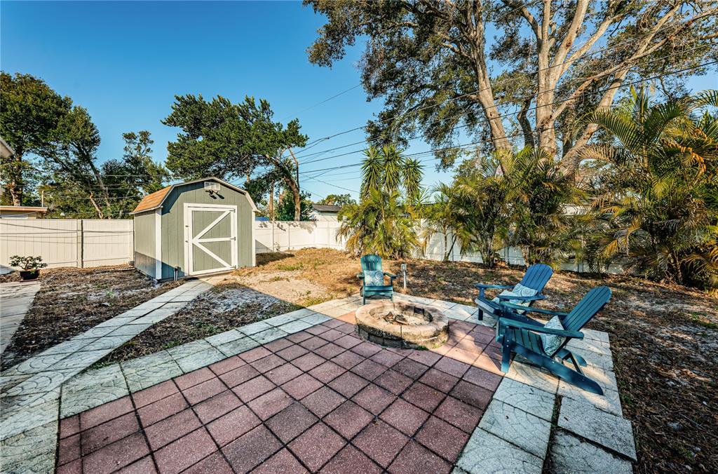 1738 Bentley Street Clearwater, FL 33755 - Photo 26 of 30 a backyard of a house with table and chairs