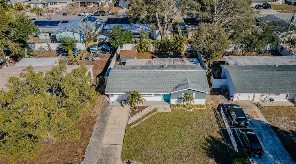 1738 Bentley Street Clearwater, FL 33755 - Photo 29 of 30 an aerial view of a house with swimming pool and large trees