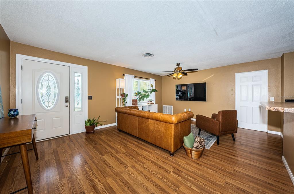 1738 Bentley Street Clearwater, FL 33755 - Photo 5 of 30 a living room with furniture a large window and wooden floor