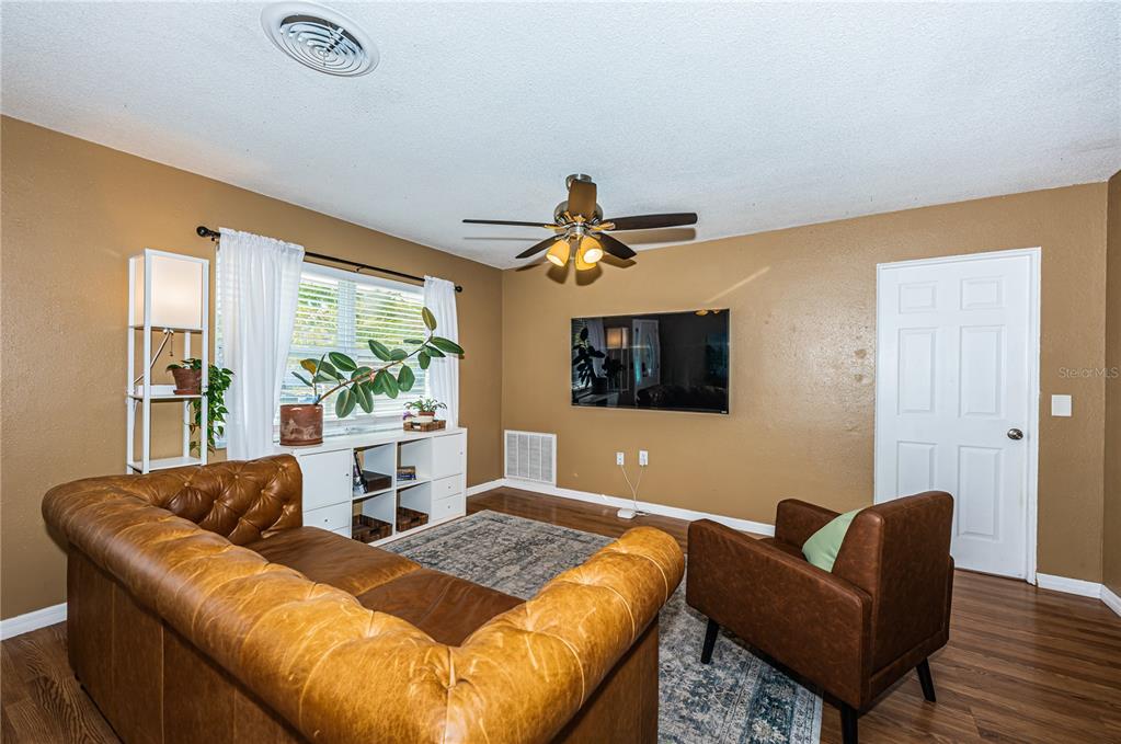 1738 Bentley Street Clearwater, FL 33755 - Photo 6 of 30 a living room with furniture and a large window