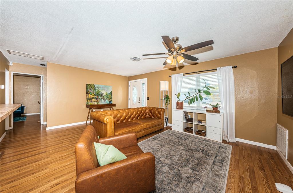 1738 Bentley Street Clearwater, FL 33755 - Photo 8 of 30 a living room with furniture and a large window