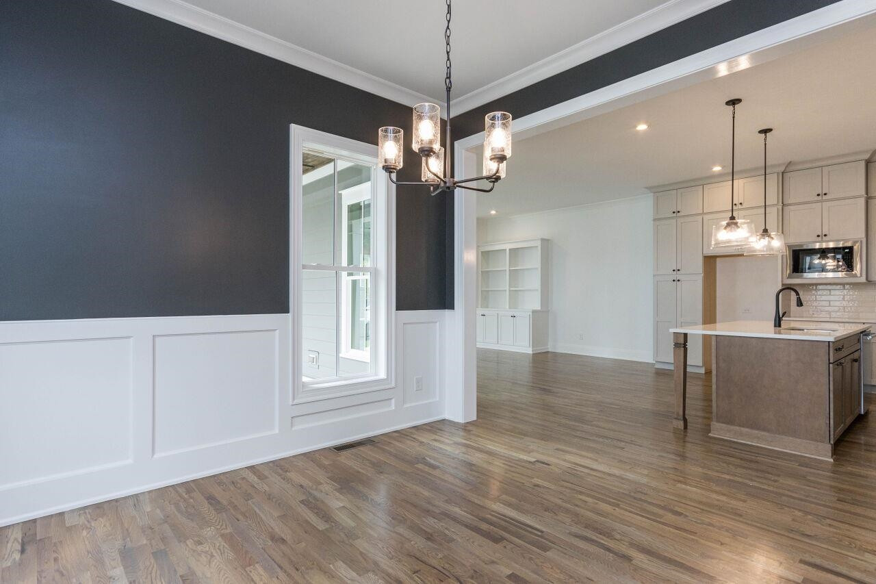 1108 Kentlands Drive Durham, NC 27713 - Photo 12 of 49 a view of a kitchen with furniture and wooden floor