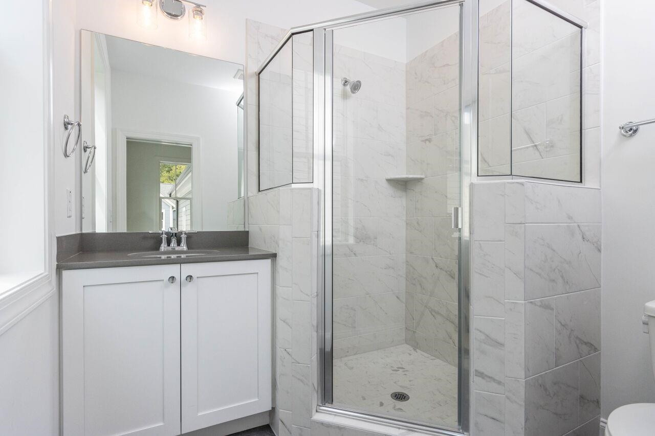 1108 Kentlands Drive Durham, NC 27713 - Photo 22 of 49 a bathroom with a shower sink and mirror