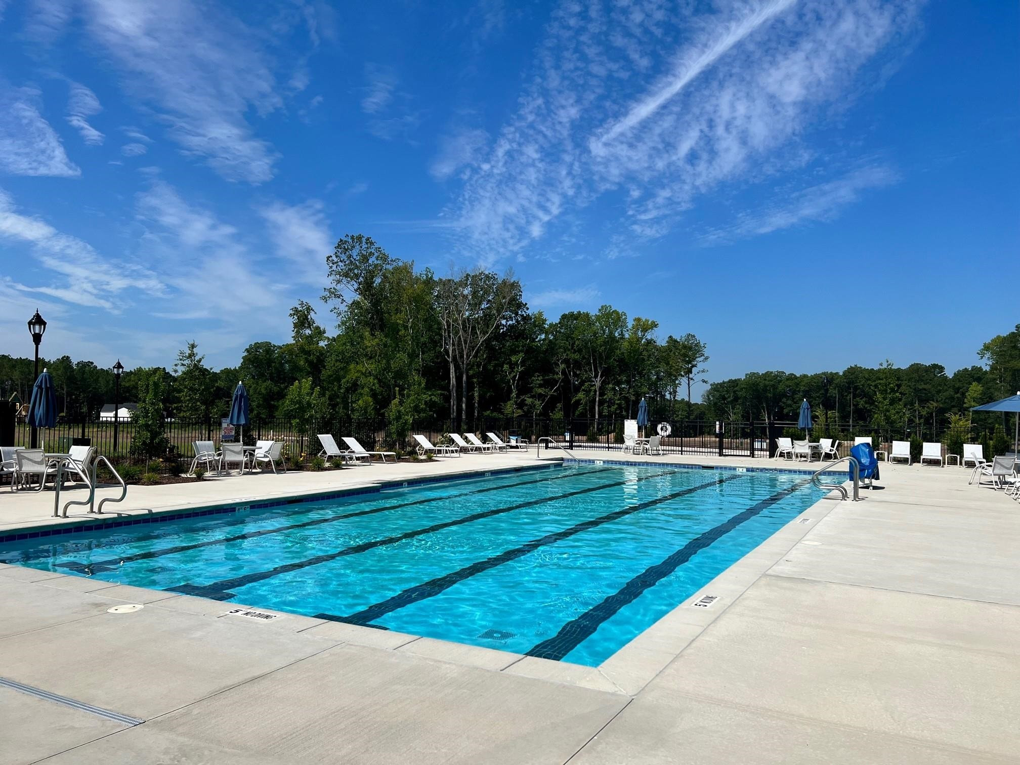 1108 Kentlands Drive Durham, NC 27713 - Photo 41 of 49 a view of swimming pool with outdoor seating and trees in the background