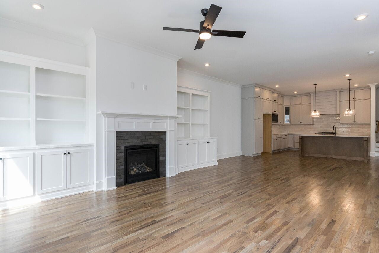 1108 Kentlands Drive Durham, NC 27713 - Photo 5 of 49 a view of a kitchen and an empty room with wooden floor