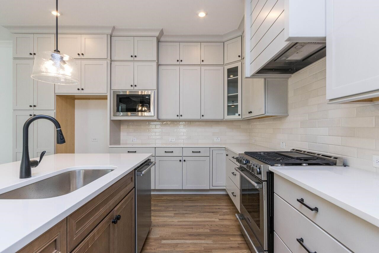 1108 Kentlands Drive Durham, NC 27713 - Photo 9 of 49 a kitchen with stainless steel appliances granite countertop a sink a stove and a refrigerator