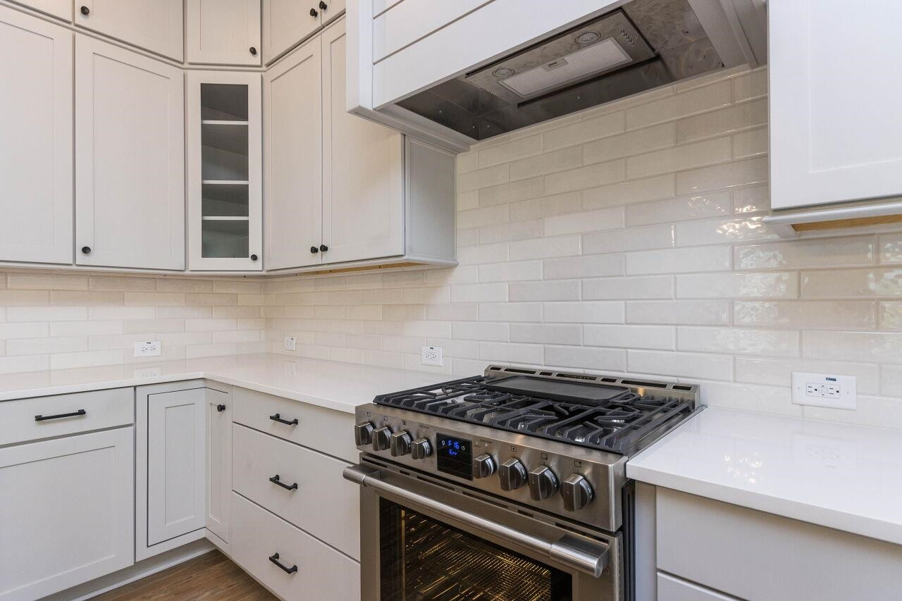 1108 Kentlands Drive Durham, NC 27713 - Photo 10 of 49 a kitchen with white cabinets and appliances