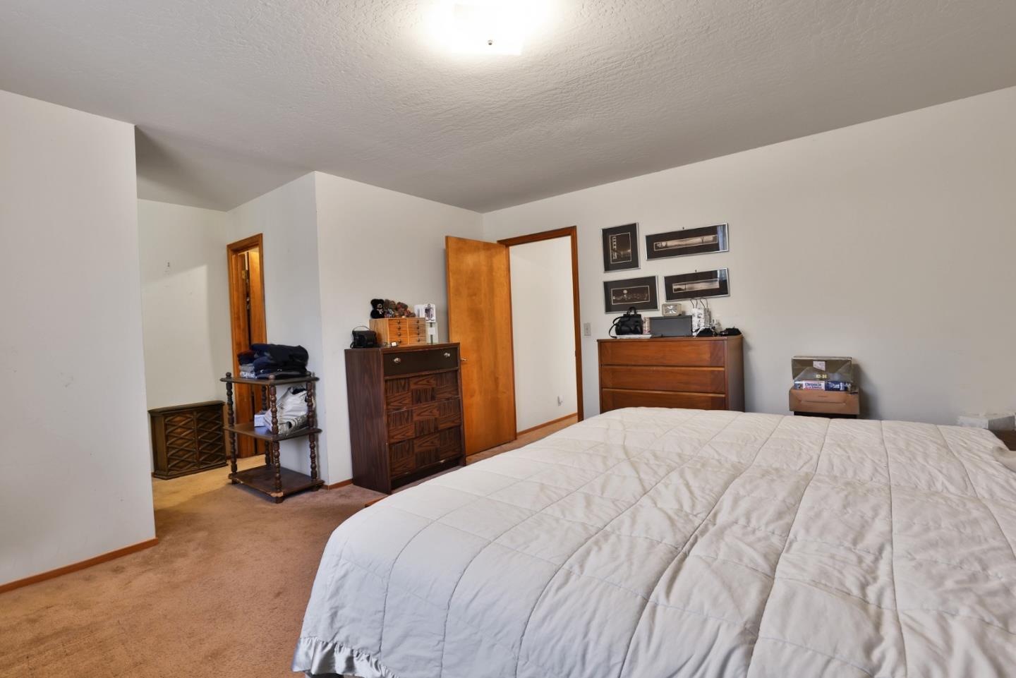 15 Rays Circle Hollister, CA 95023 - Photo 20 of 41 a bedroom with a bed and a large mirror