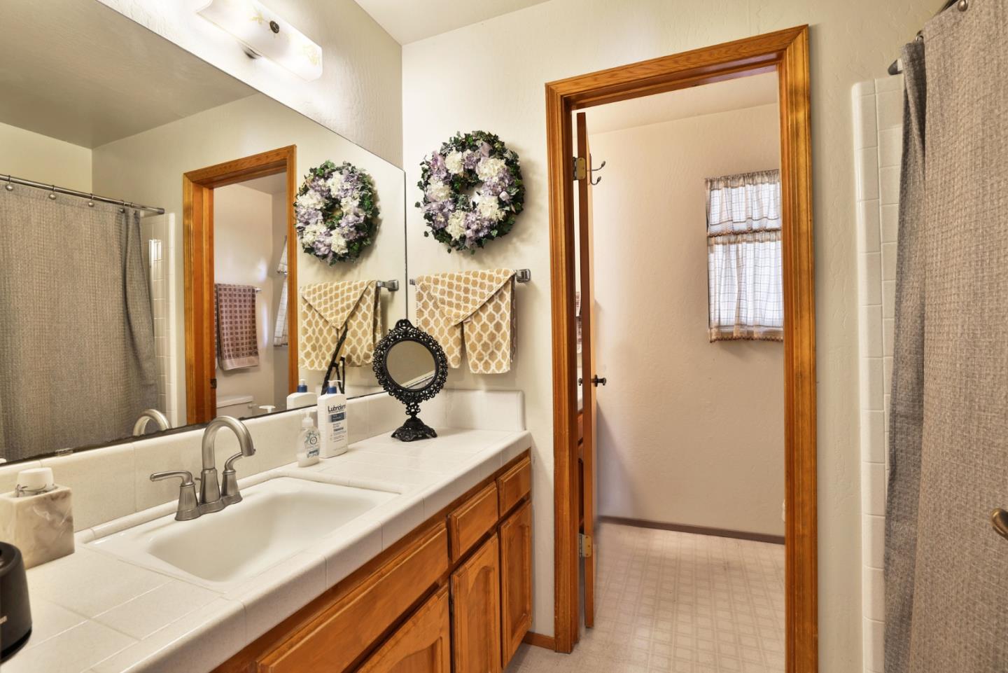 15 Rays Circle Hollister, CA 95023 - Photo 25 of 41 a bathroom with mirror and a sink