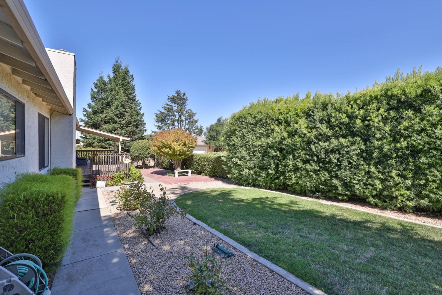 15 Rays Circle Hollister, CA 95023 - Photo 31 of 41 a view of a yard with flower plants and wooden fence