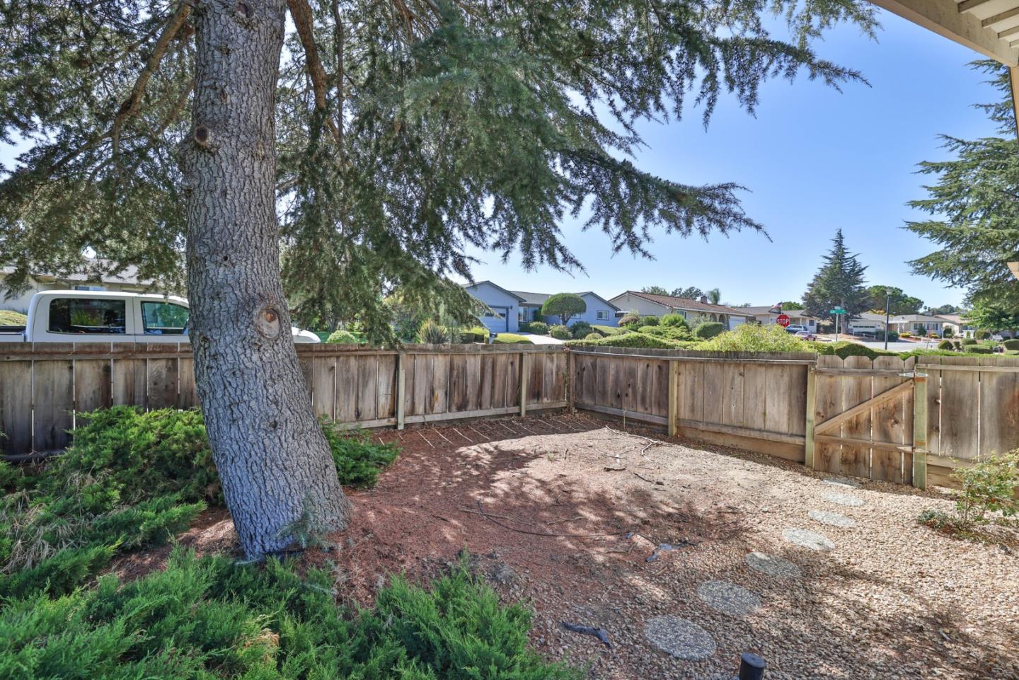15 Rays Circle Hollister, CA 95023 - Photo 36 of 41 a view of a backyard with a large tree and wooden fence