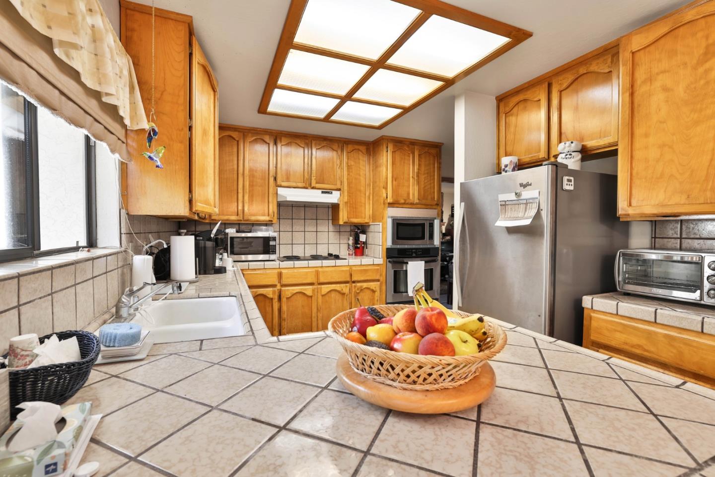 15 Rays Circle Hollister, CA 95023 - Photo 10 of 41 a kitchen with stainless steel appliances kitchen island granite countertop a refrigerator a stove a sink and dishwasher a oven with large window