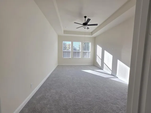 an empty room with closet and windows